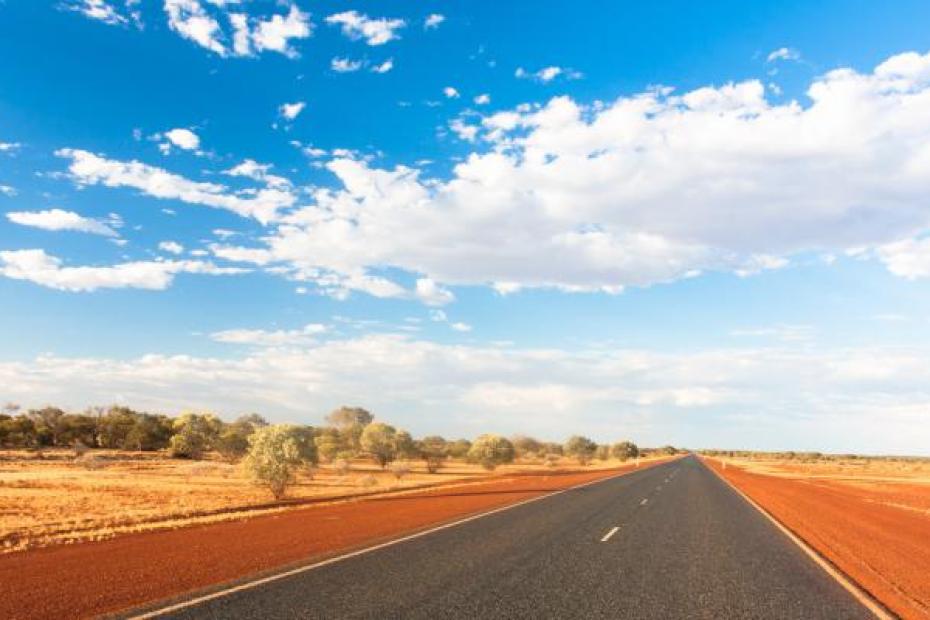 An image of a road in Central Australia surrounded by country