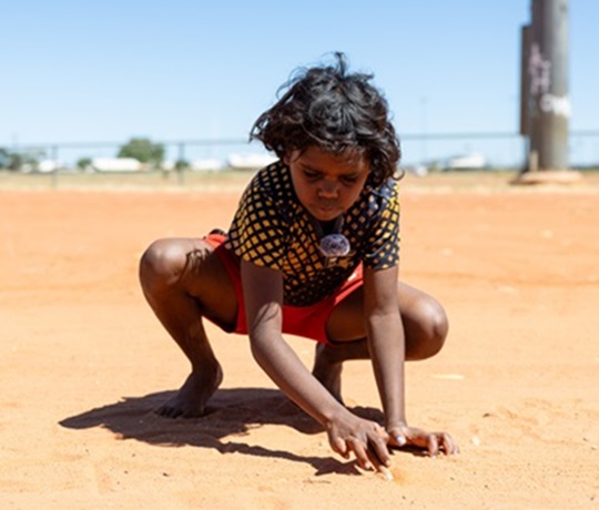 Young Yuendumu resident attending the junkyard beats documentary film making school holiday program.