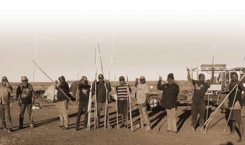 Kiwirrkurra Rangers holding spears at a Men’s Culture Camp
