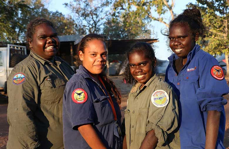 Four female Indigenous rangers standing together at the Strong Women for Healthy Country Network Forum