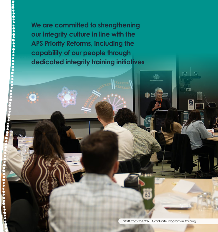 people in a workshop looking at a speaker and projector screen presentation