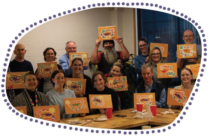 14 people holding paintings