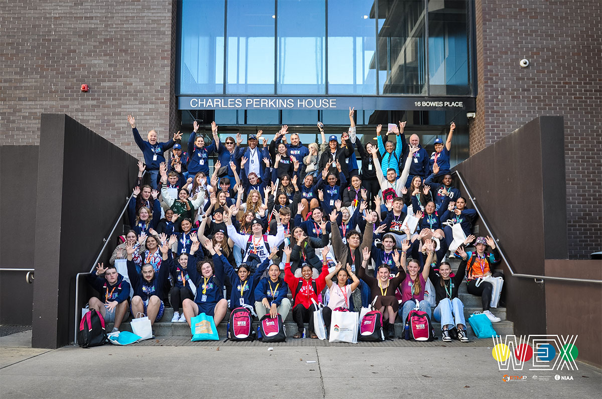 Secondary school students sitting on the steps of the National Indigenous Australians Agency Charles Perkins House as part of WEX Canberra.