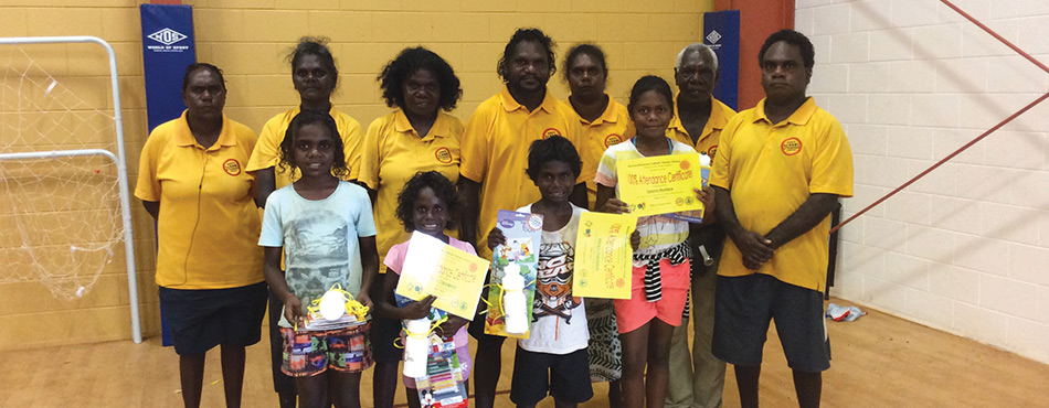 Pictured in this photograph are three students from Tiwi, receiving their awards for excellent school attendance.