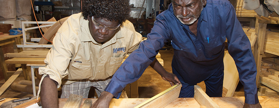 In this photograph, Brendan Marrilama is being taught how to build furniture which will be sold to stimulate the economy in Milingimbi