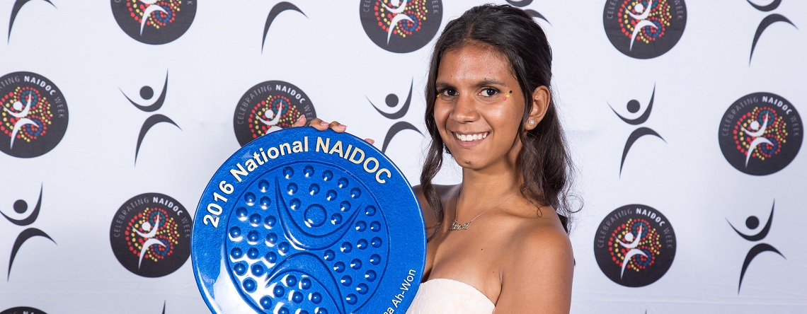Female Indigenous youth holding her 2016 National NAIDOC Award