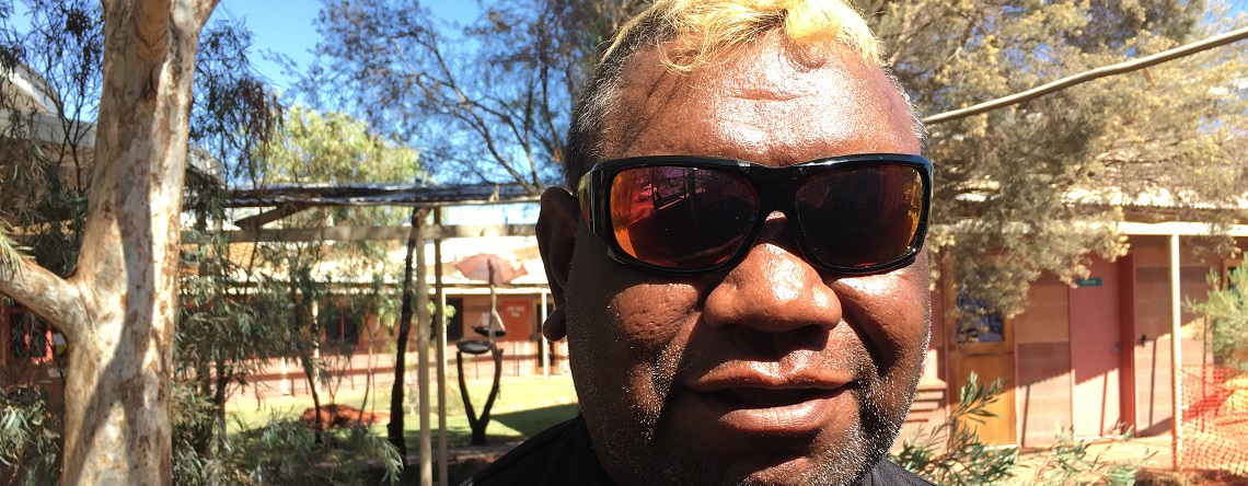 Photograph of Indigenous man Lance McDonald with sunglasses on, smiling at the camera