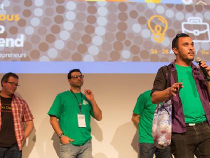 Participants in the Indigenous Startup Weekend, standing on stage giving a presentation