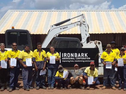 Members of the Community Development Program Ironbark project, standing together holding certificates