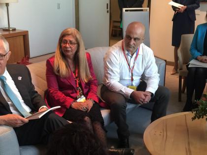 A group of people sitting, meeting with the Prime Minister in an office