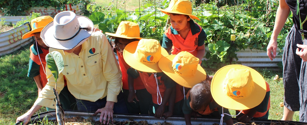 In this photo students from the Ngalangangpum School are shown tending to the school garden with EON Foundation staff at Warmun in the East Kimberley. The EON Foundation has worked with remote Aboriginal communities for more than 10 years to make healthy choices easy choices.