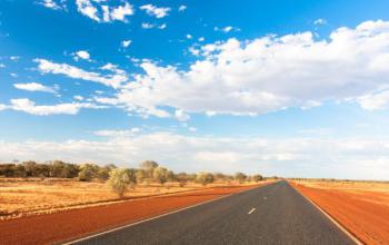 An image of a road in Central Australia surrounded by country