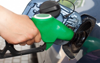 Image of a hand on a petrol pump