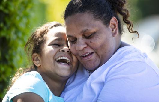 Mother and daughter embracing with a smile