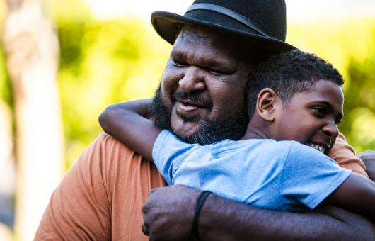 Man and boy hugging
