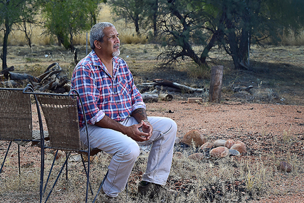 Image of Michael Liddle sitting in a chair, looking into the background