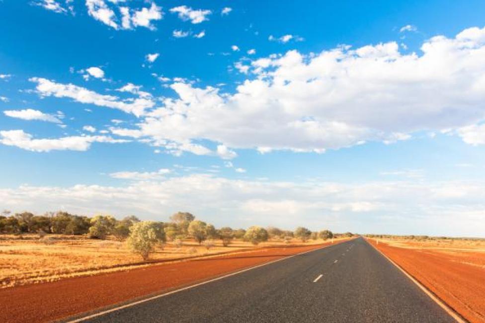 An image of a road in Central Australia surrounded by country