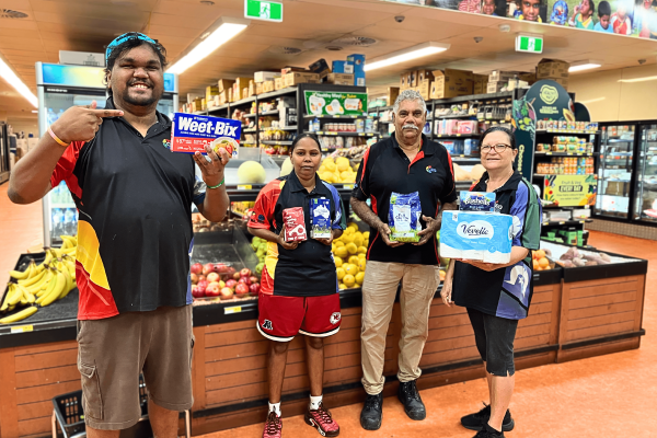 People hold items in a supermarket
