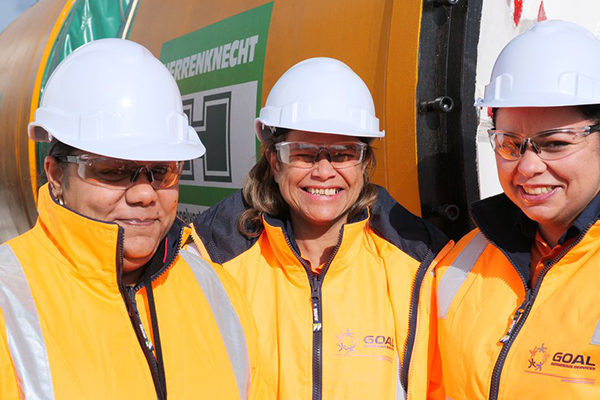 Image of Kristy Stewart and two coworkers outside a drilling engine