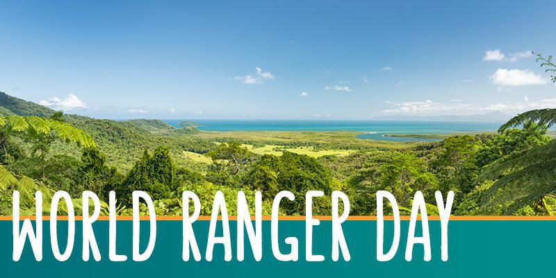 At right is image of rainforest in foreground and sea and sky in the background. At left are the words: World Ranger Day.