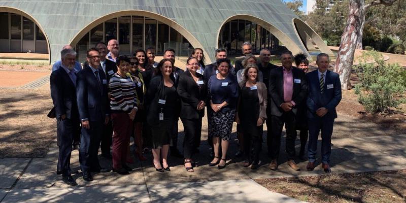 Twenty-three Indigenous leaders from the public services across Australia and New Zealand pose for a picture in front of the Shine Dome in Canberra, Australia