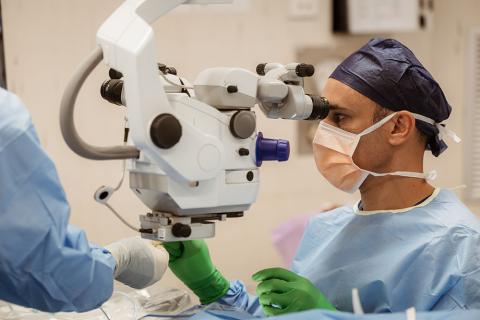 Ophthalmologist, Associate Professor Dr Kris Rallah-Baker performing cataract surgery on an IRIS patient