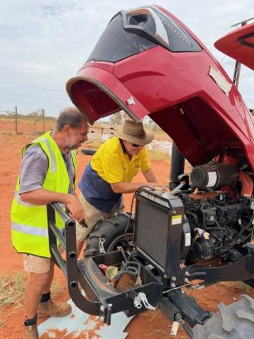 James Torres and Karl Walter (Works Manager) inspecting community-based tractor.  These tractors were funded under the RJED program and have been a boon for making the field staff more productive in their respective homelands