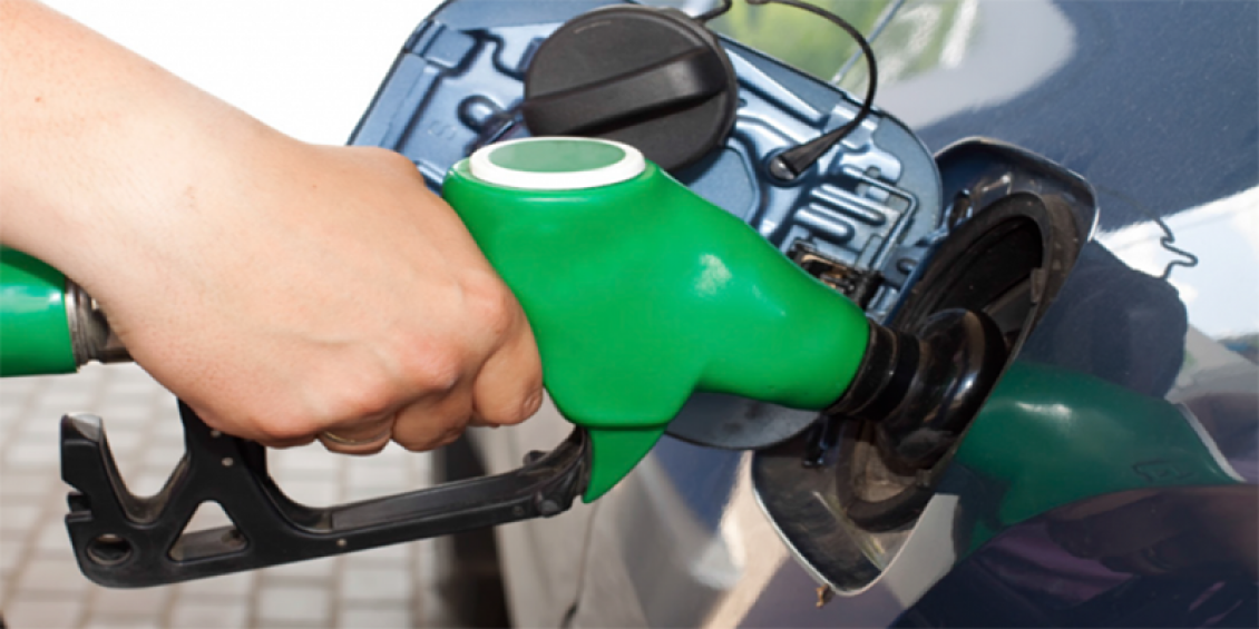 Image of a hand on a petrol pump